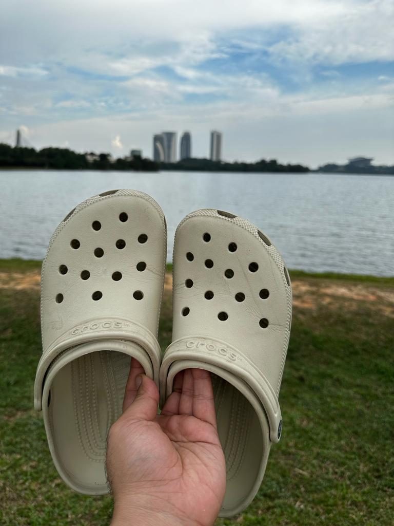 Bone Crocs held up in direct sunlight looking creamy off-white